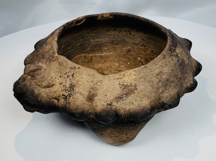Rare ancient West Mexican ceramic tripod bowl displaying three hollow supports and stylized zoomorphic head decoration.