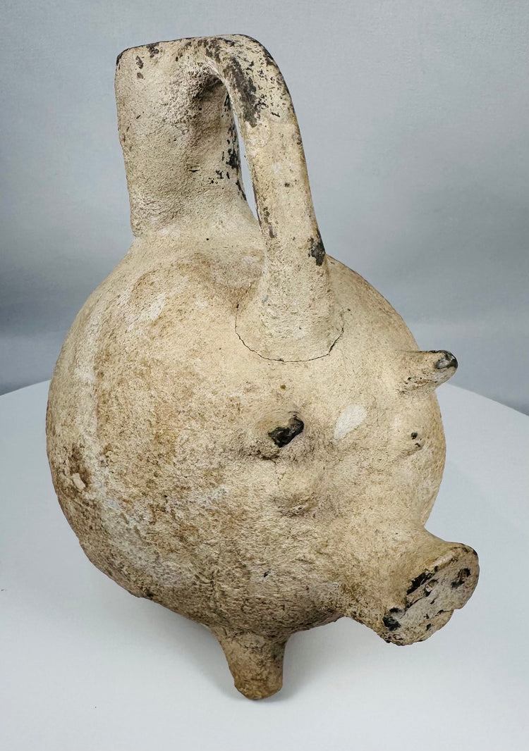 Authentic Yortan Culture pig-form ceramic vessel displaying mineral deposits and burial encrustation.