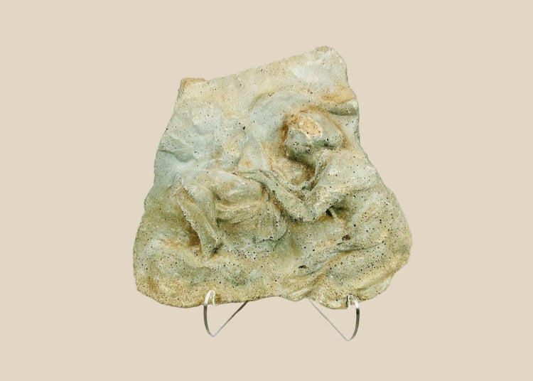Ancient carved limestone relief fragment from the Mediterranean or Near East, Classical Period (circa 500 BCE–500 CE). Features two expressive human figures, likely part of a larger mythological or commemorative scene. Weathered surface and patina reflect centuries of age and Classical artistic traditions.
