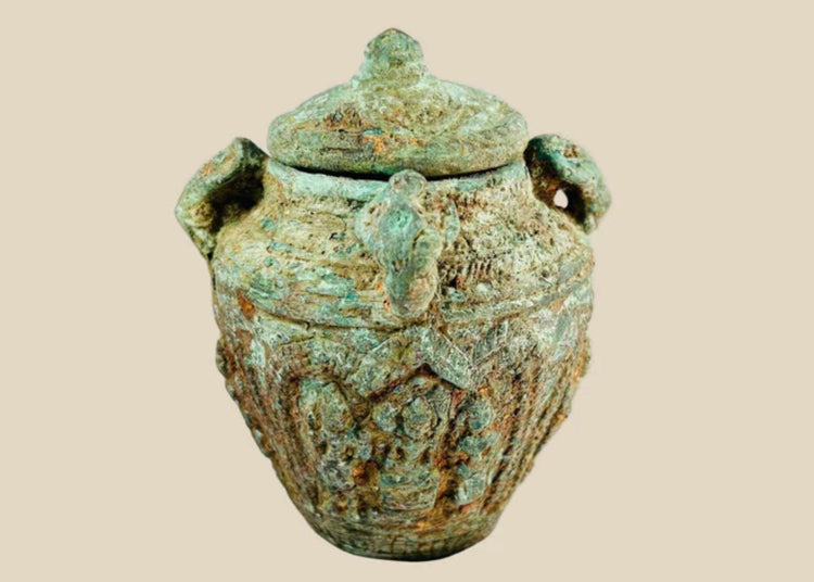 Early Chinese ritual bronze jar with lid and four decorative handles, intricate surface motifs, rich patina, Shang or Zhou dynasty, circa 1600–256 BCE, used for ceremonial or ancestral offerings.