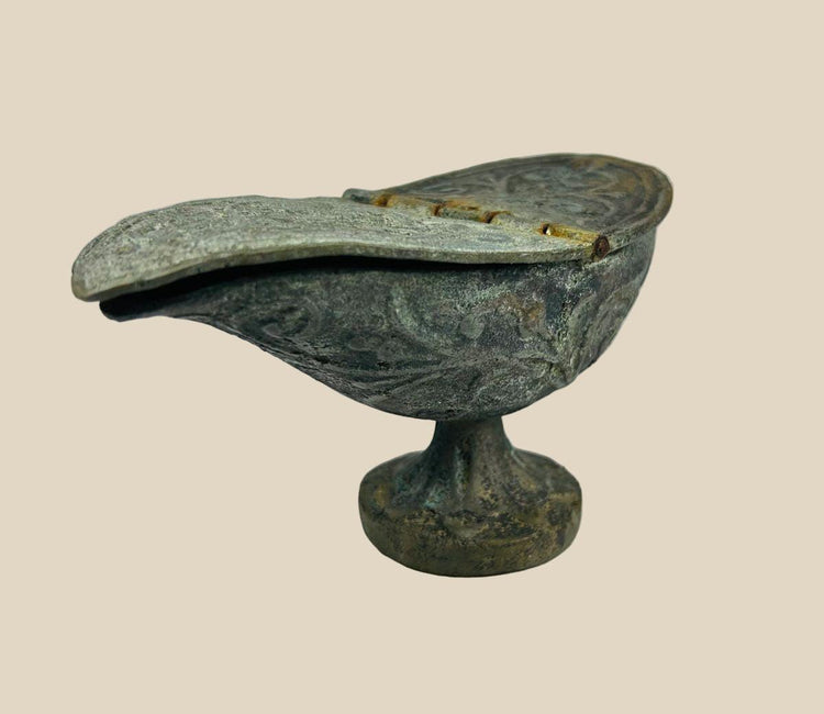 Ancient Chinese bronze oil lamp from the Han Dynasty, circa 206 BCE – 220 CE, pedestal base with hinged lid and engraved decorative motifs.