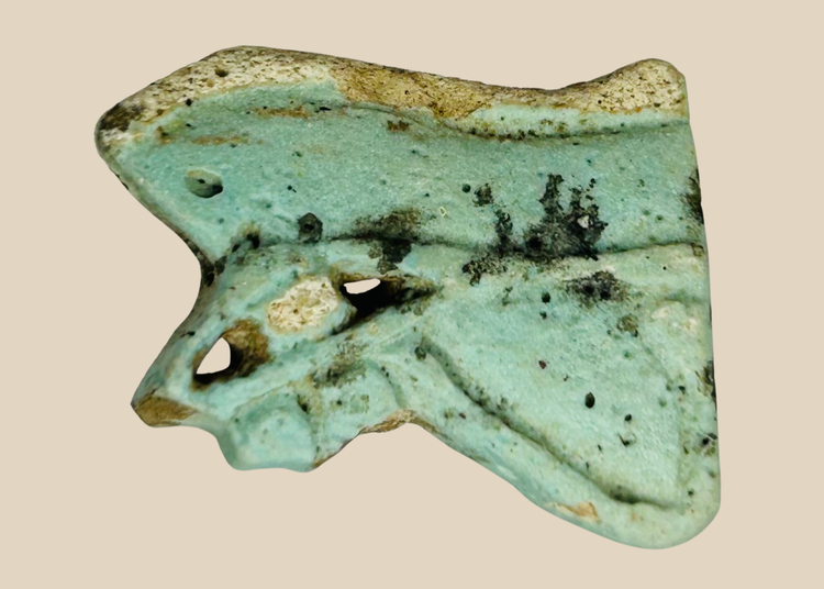 Ancient Egyptian faience Eye of Horus amulet fragment in blue-green glaze with burial patina