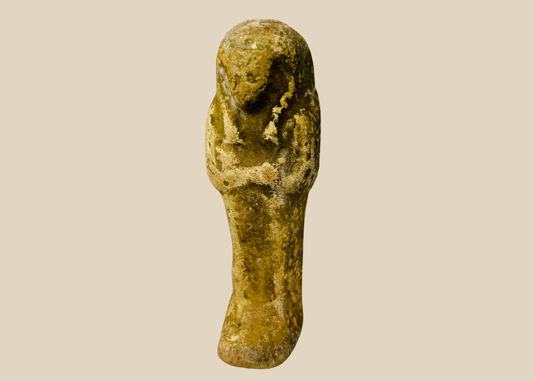 Ancient Egyptian sandstone ushabti figurine displayed on a white background.