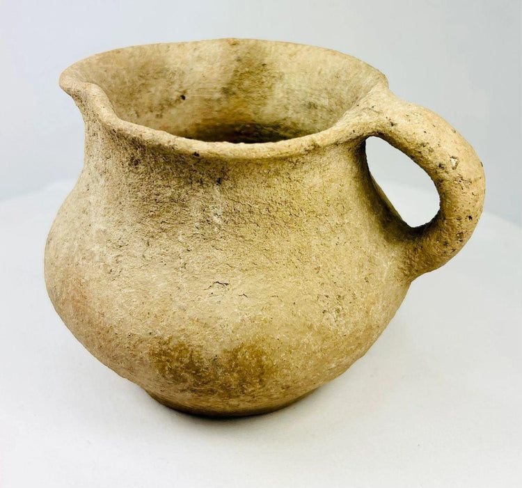Ancient Greco-Roman terracotta pitcher, 1st–3rd century CE, with single rounded handle, wide mouth, and aged earthen surface.
