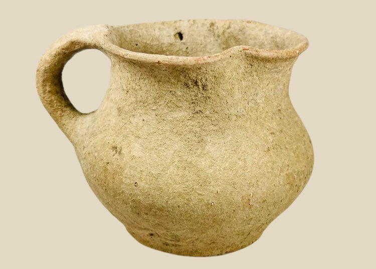 Ancient Greco-Roman terracotta pitcher, 1st–3rd century CE, with single rounded handle, wide mouth, and aged earthen surface.