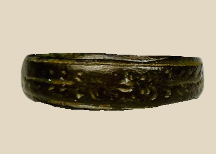 Ancient Roman bronze band ring, 1st–4th Century CE, featuring incised decorative motifs around the circumference. Worn as personal adornment and possibly symbolic of status or identity, with natural patina from centuries of age and use.