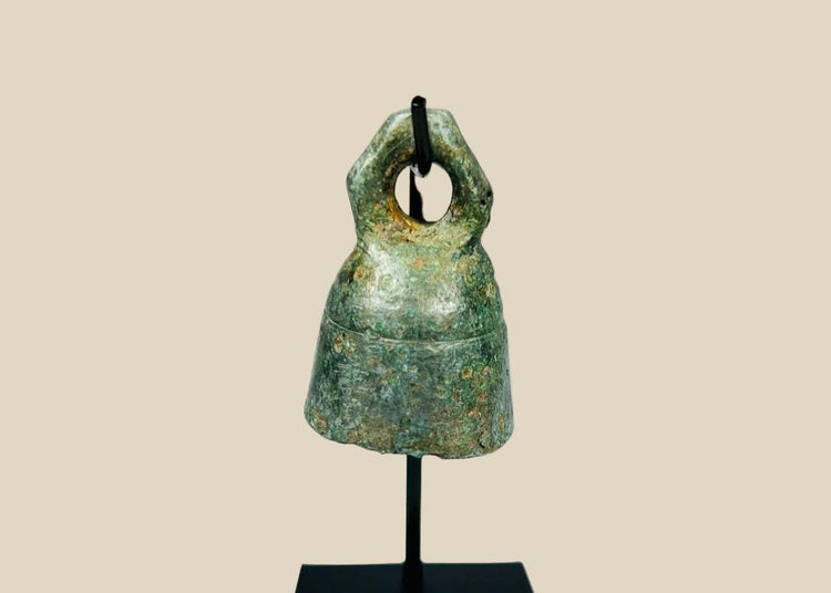 Ancient Roman cast bronze bell, 1st–4th century CE, with suspension loop, rich green patina, and mounted display stand.
