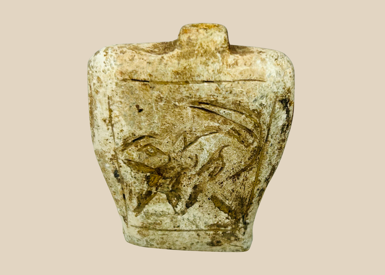 Ancient carved stone amulet flask with double-sided relief motifs and burial patina