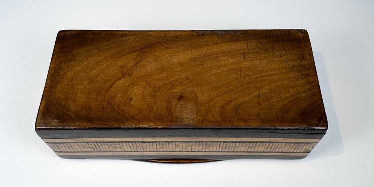 Underside of Anglo-Indian marquetry box showing natural wood base and antique construction