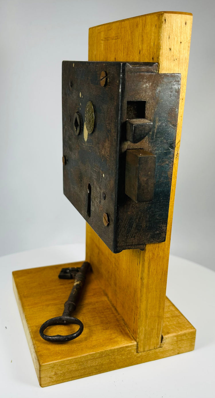 Industrial era forged iron lock with maker stamp and bolt mechanism