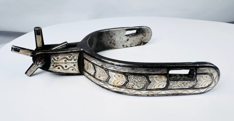 Hand-forged Western steel spurs with broad heel bands and decorative inlay