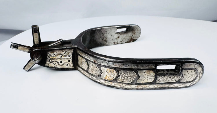 Hand-forged Western steel spurs with broad heel bands and decorative inlay