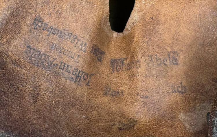 Close-up of original leather chinstrap, buckle and interior fittings on Bavarian firefighter helmet