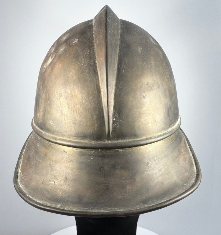 German brass Feuerwehrhelm showing rounded side profile and historic surface wear, circa 1908–1934
