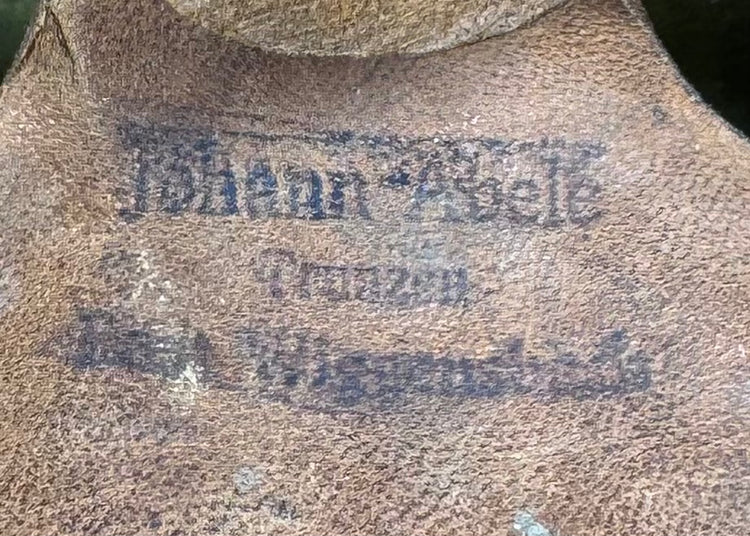 Detail of faded ink markings on original leather liner of Bavarian German firefighter helmet