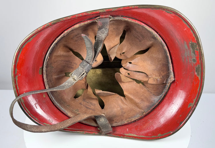 Bavarian firefighter helmet showing extended rear neck guard and aged brass shell, circa 1908–1934