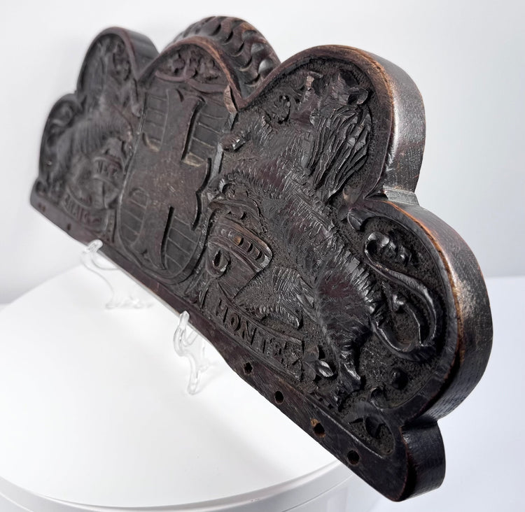 Close-up of the weathered oak surface, carved lion, heraldic shield, and naturally developed wear