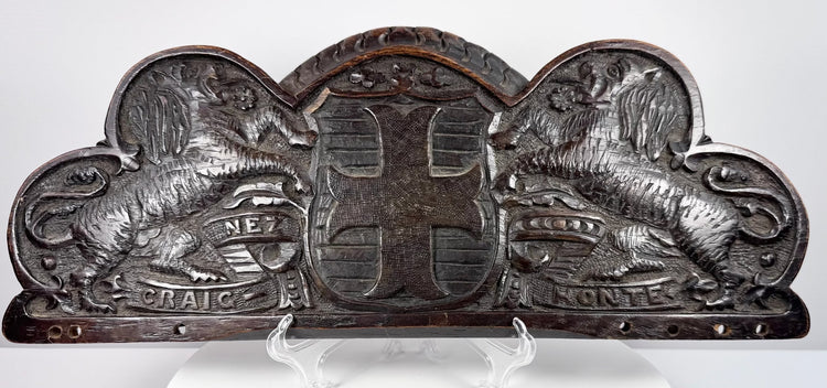 Antique carved oak pediment with two double-queued heraldic lions flanking a central coat of arms