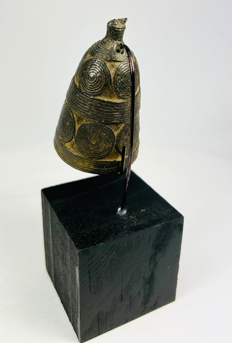 Tibetan Buddhist ritual bell with domed body and intact iron clapper interior.