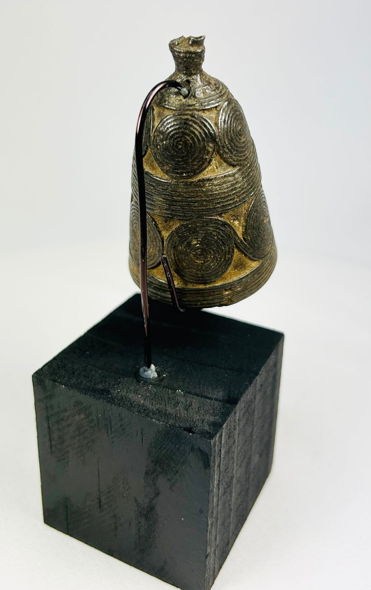 Antique Himalayan ghanta bell showing dark ritual patina and detailed vajra handle.