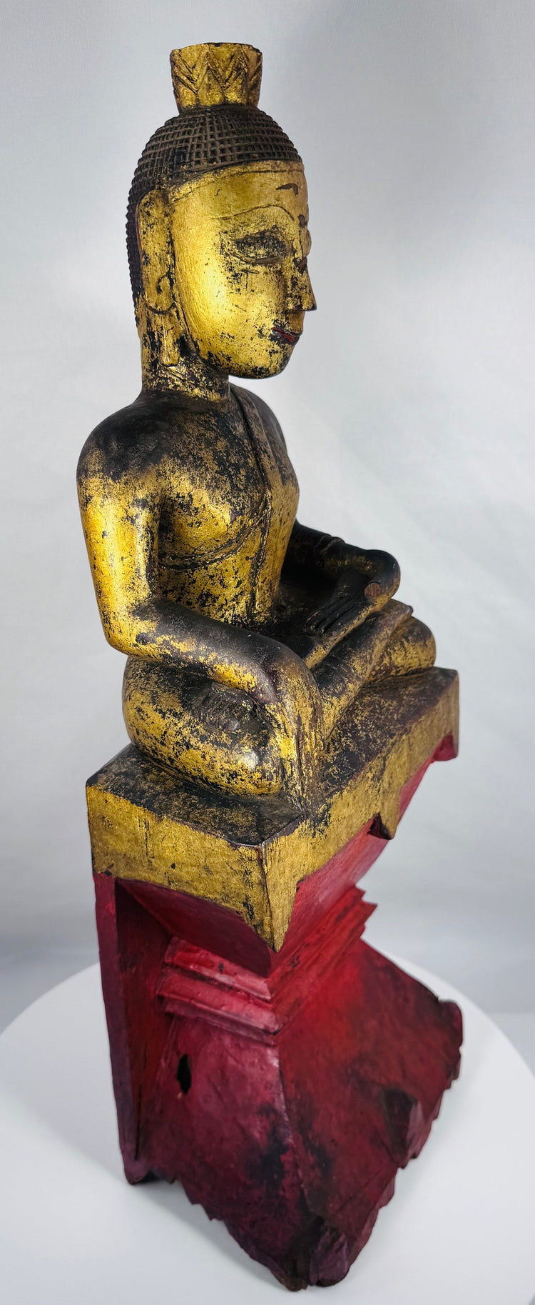Historic Burmese Buddha image with surviving gold leaf decoration and red lacquer base.