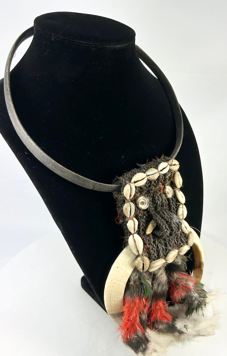 Traditional Melanesian necklace with curved shell elements and red-black feathers
