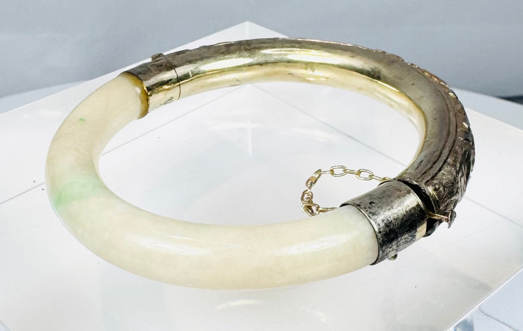 Vintage hinged bracelet with natural green stone inclusions and marked silver fittings