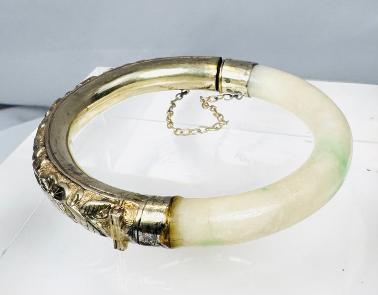 Antique Asian jewelry bracelet with pale stone segment and ornate silver floral panel