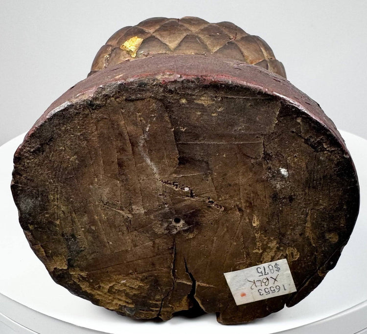 Base of antique Chinese wooden statue showing aged grain, red pigment traces and label