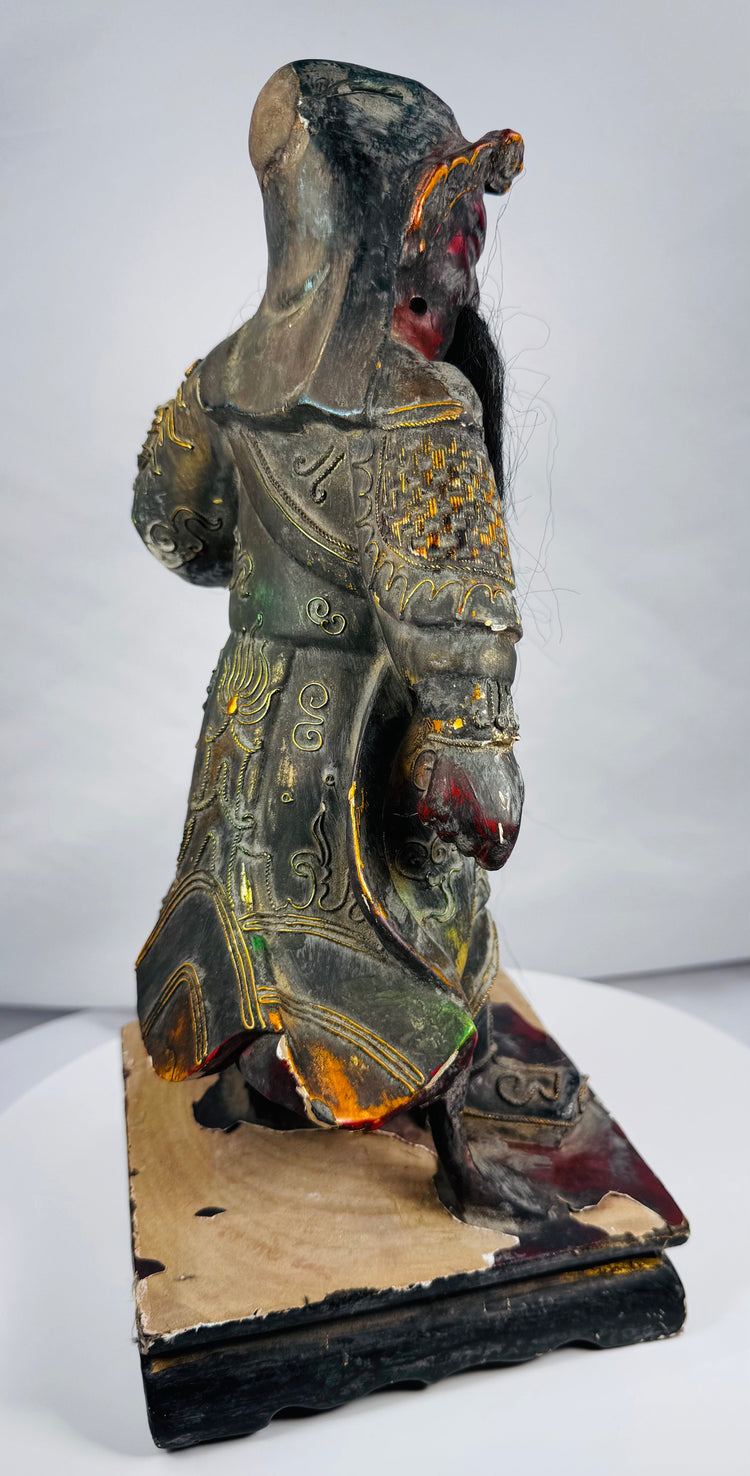 Chinese protective deity figure with elaborate armour and missing handheld weapon