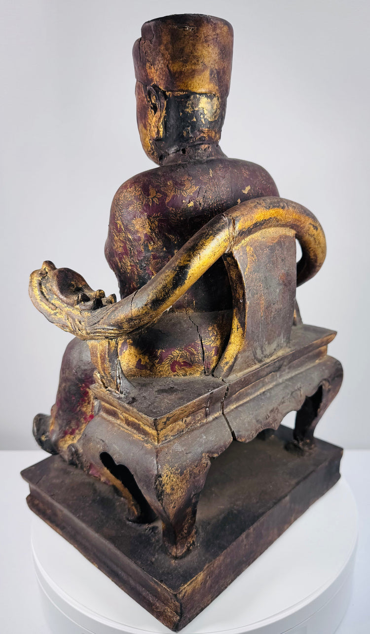 Close-up of Chinese carved wooden official showing dignified facial features, elongated ears and tall square ceremonial cap