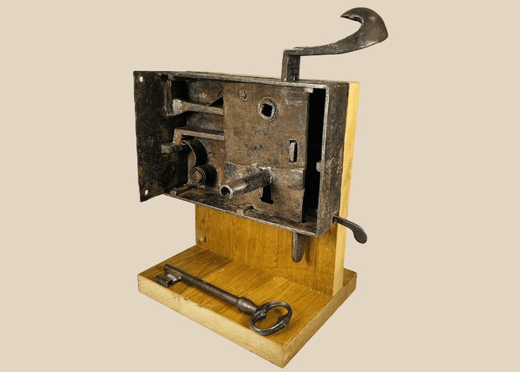 Antique iron door lock mechanism with visible internal bolts and large key