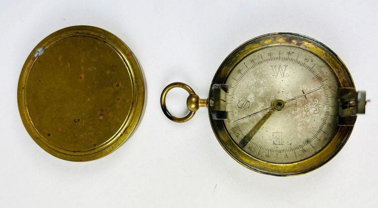 19th-century French brass compass featuring fleur-de-lis dial and vanes
