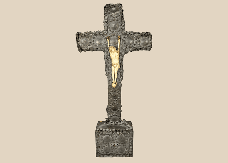 Antique crucifix — direct frontal view highlighting detailed casting and aged patina.