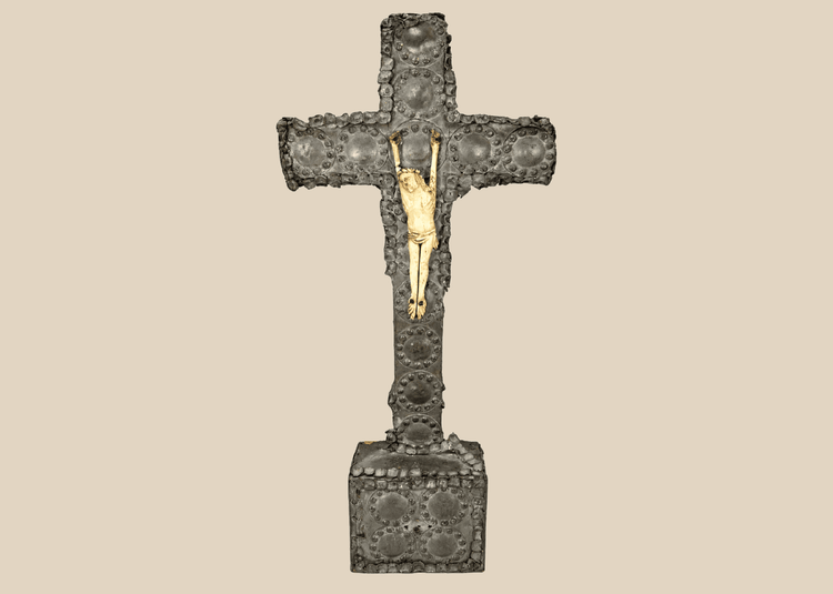 Antique crucifix — direct frontal view highlighting detailed casting and aged patina.