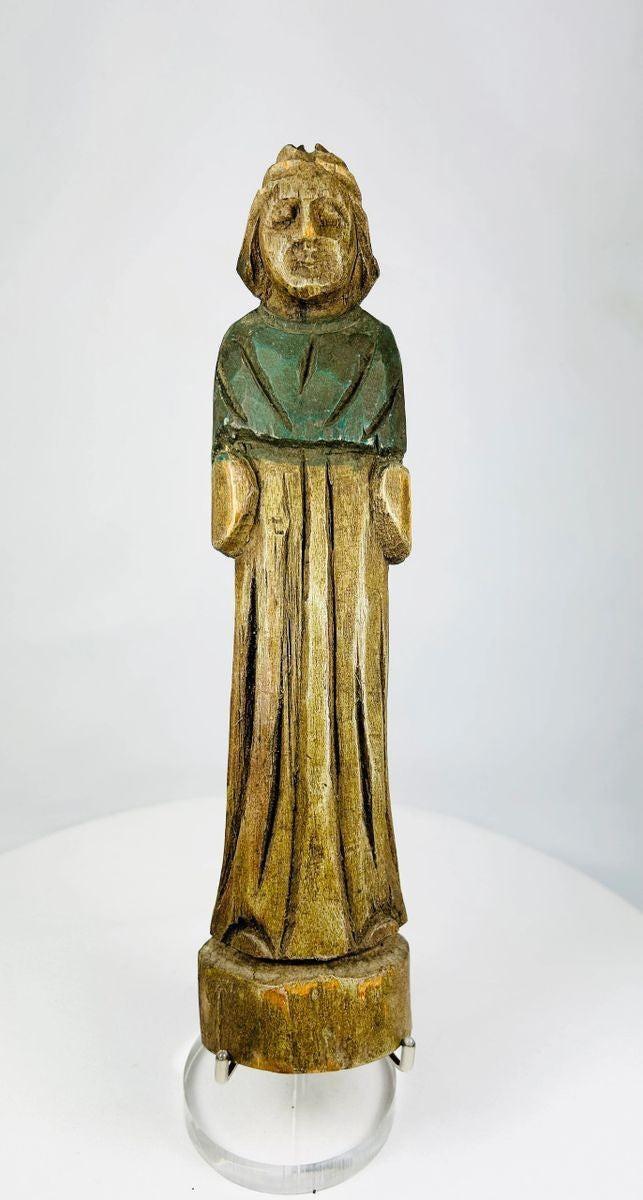 Detail view showing original painted garment traces on carved wooden figurine.