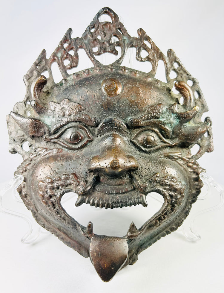Himalayan ritual bronze mask depicting a fierce protective deity, Nepal or Northern India, late 19th–early 20th century