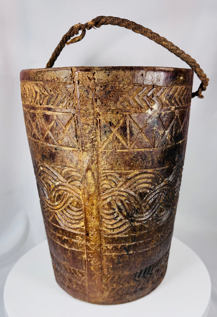 Antique ethnographic wooden container with interwoven carved motifs and darkened aged surface