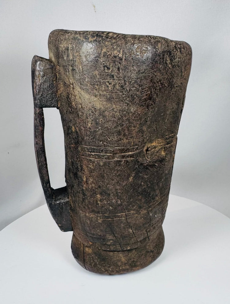 Himalayan carved hardwood vessel with decorative incised bands and worn utilitarian finish