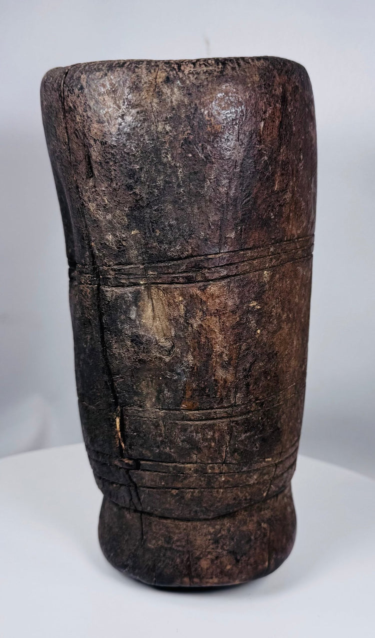 Hand-carved Tibetan hardwood vessel featuring aged cracks, tool marks, and integral side handle