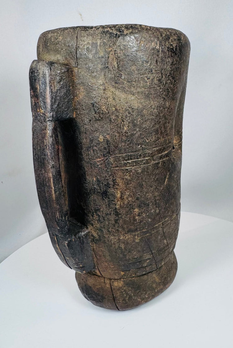 Traditional Tibetan carved wooden butter vessel with shrinkage cracks and hand-worked surface