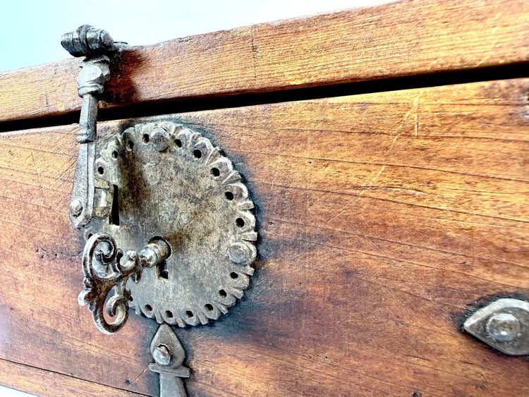 Antique Asian wooden lockbox with an original functional iron lock, elaborate metal hardware, and aged elmwood construction.