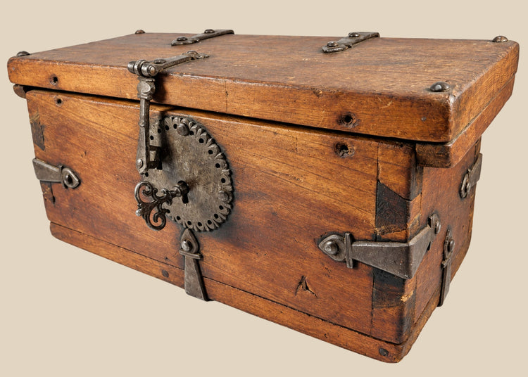 Antique Himalayan lockbox, circa 1780–1820, crafted from elmwood with original hand-forged iron fittings, circular hasp plate, ornate key, and rich aged patina. Historical chest from Northern India, Nepal, or Tibet used for safeguarding valuables.