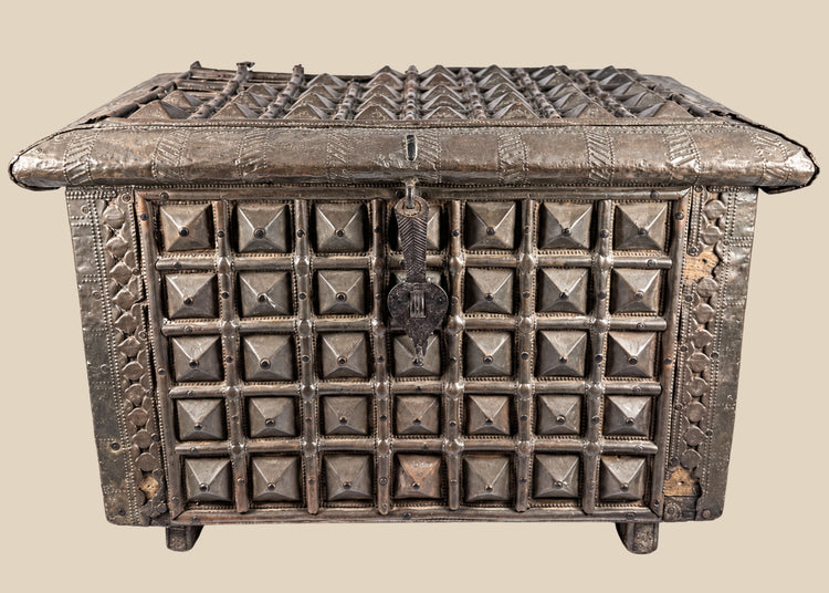 Late 19th-century Indian lidded box made of hardwood with brass cladding, featuring embossed geometric and pyramid-like designs. Original lock and latch intact. Combines traditional Indian craftsmanship, functional storage, and decorative elegance.