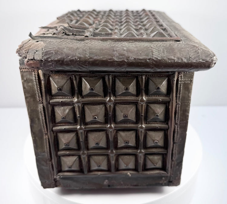 Close-up of antique Indian hardwood box with brass pyramid stud detailing and rivets