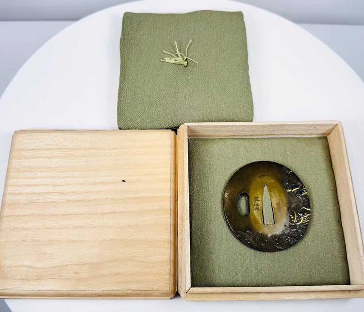Late Edo Eizui sword guard with central nakago-ana, kozuka-hitsu-ana and Japanese signature beside the opening