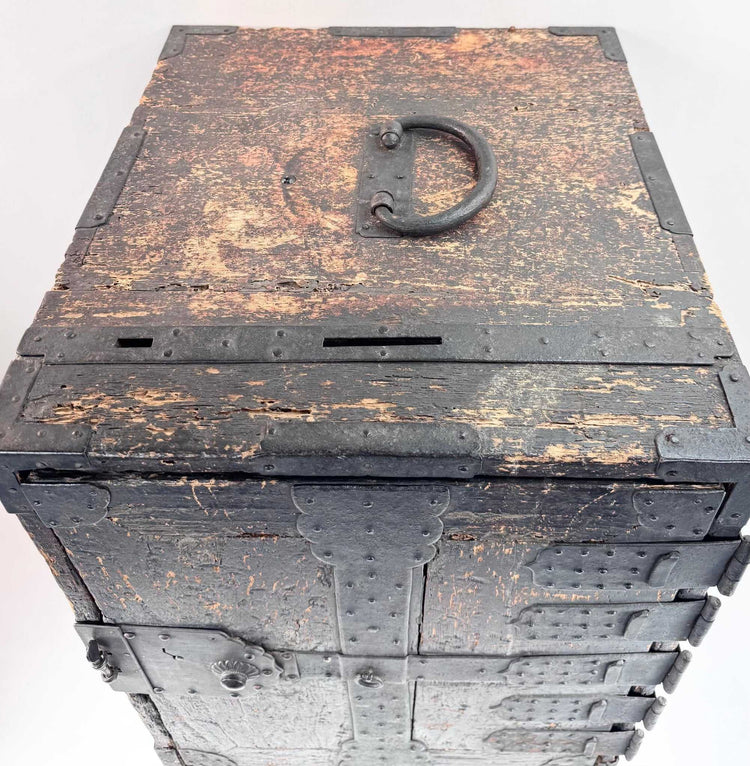 Top view of Japanese ship chest showing large iron carrying handle, deposit slots and heavily worn black finish