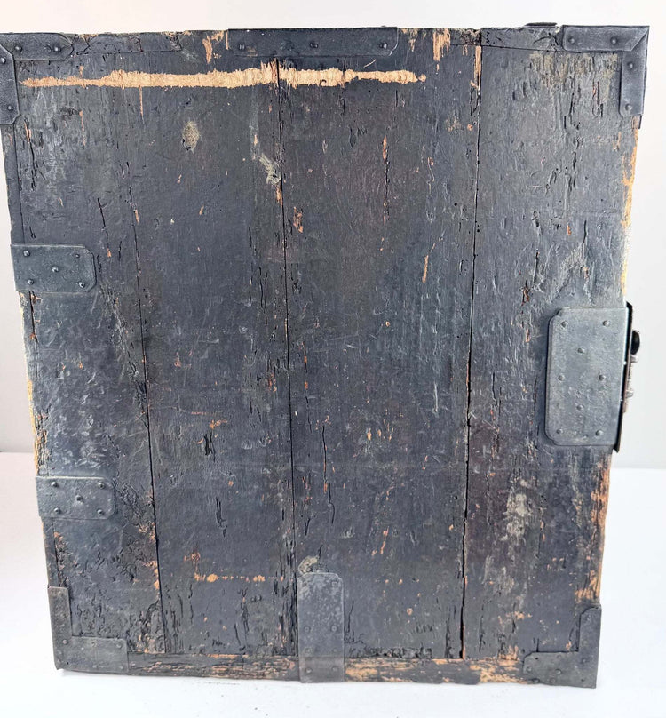 Side view of antique funa tansu displaying iron reinforcement bands, aged wood surface and maritime chest construction