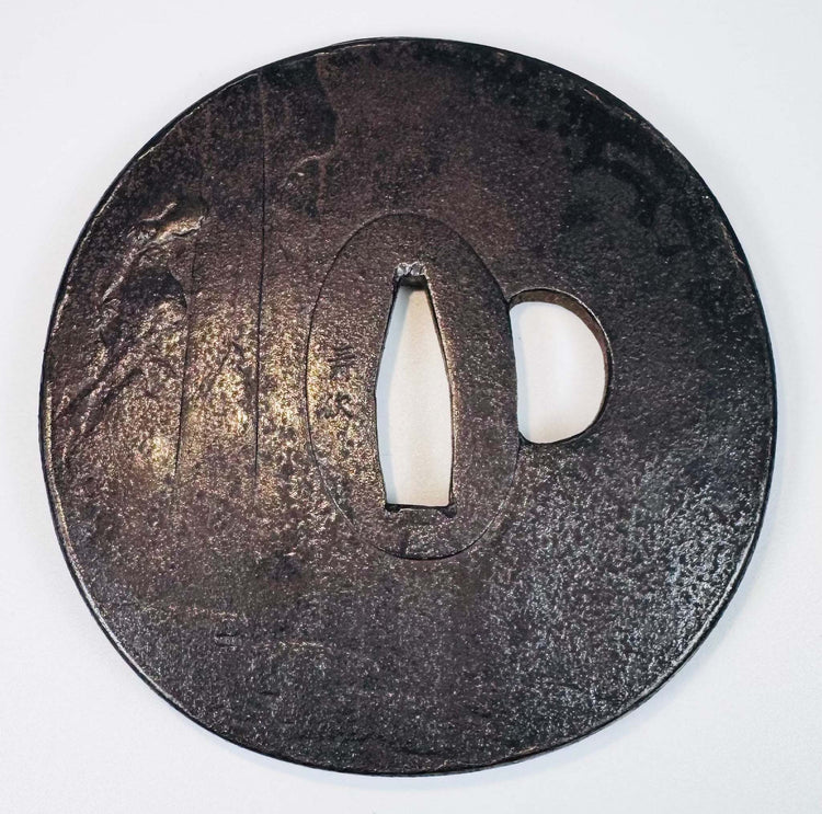 Reverse view of the Japanese iron sword guard showing its dark patina, central nakago-ana, and kozuka-hitsu-ana