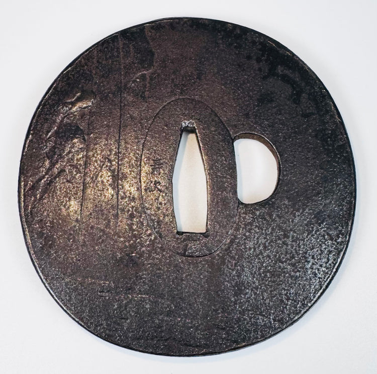 Reverse view of the Japanese iron sword guard showing its dark patina, central nakago-ana, and kozuka-hitsu-ana